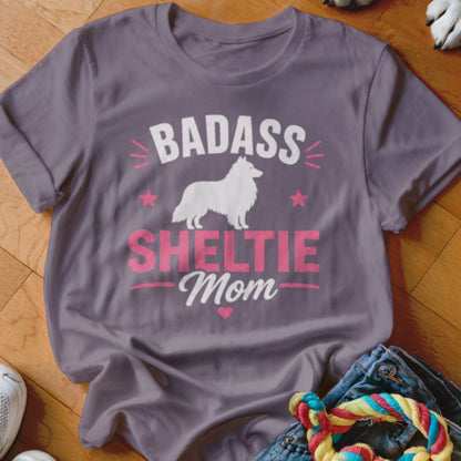 Grey t-shirt with white Sheltie silhouette and pink text "BADASS SHELTIE Mom".