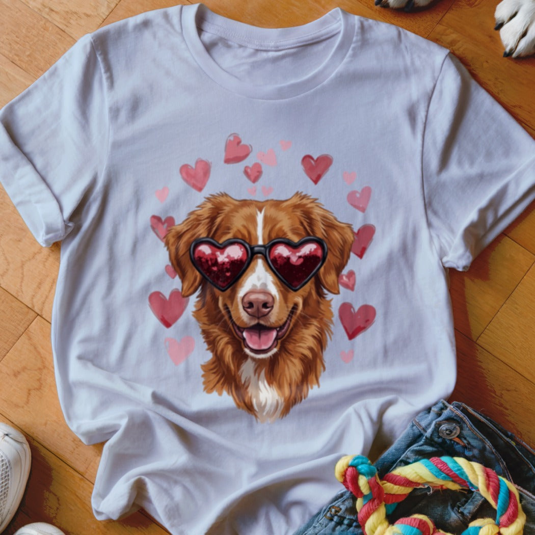 A white short-sleeved t-shirt featuring a graphic of a brown dog wearing heart-shaped sunglasses surrounded by pink hearts.