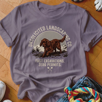 T-shirt graphic with brown dog digging, text "Unsolicited Landscaping Co." and "Fast Excavations. Zero Permits."