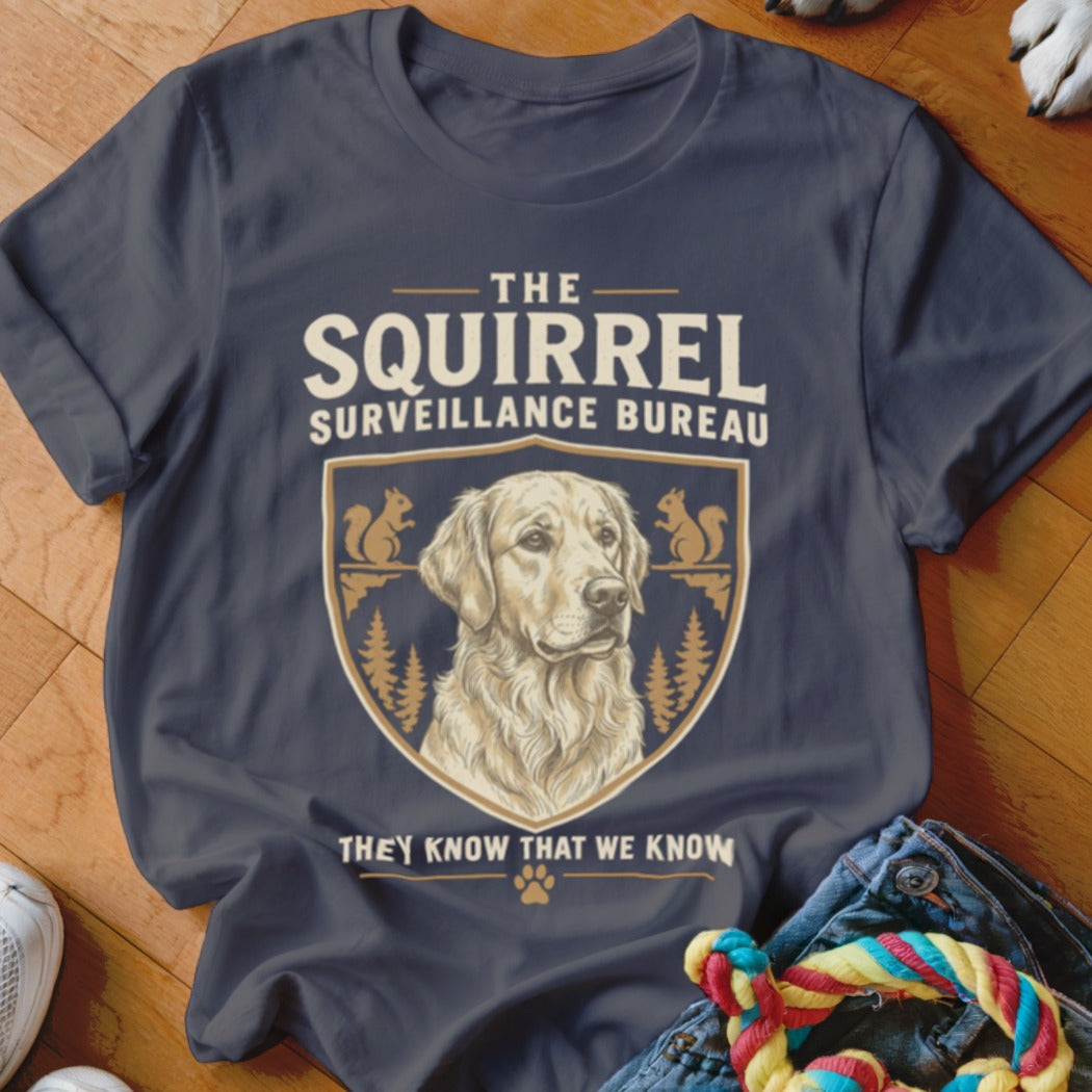 Dark grey t-shirt featuring a Golden Retriever illustration and text reading The Squirrel Surveillance Bureau.