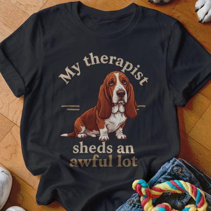 Black t-shirt with a Basset Hound illustration and text: "My therapist sheds an awful lot."