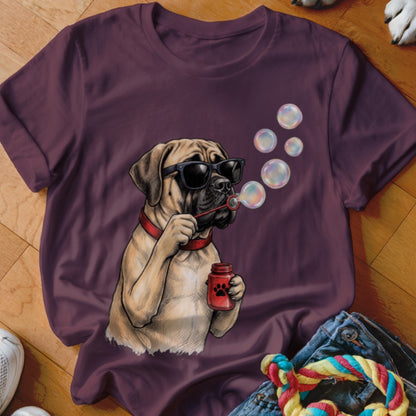 A dark purple t-shirt featuring an illustration of a dog wearing sunglasses and blowing bubbles.