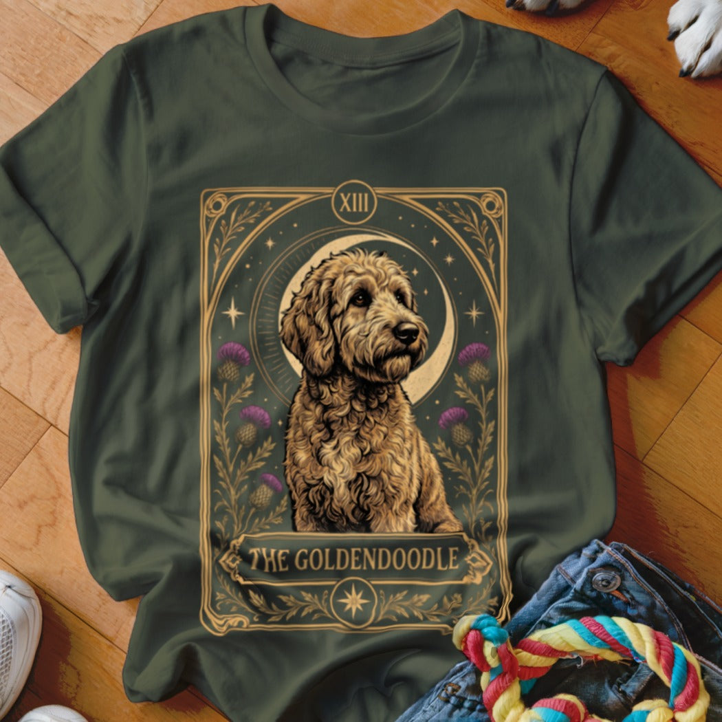 Dark green t-shirt featuring a tarot card graphic of a golden doodle with purple thistles and a moon.