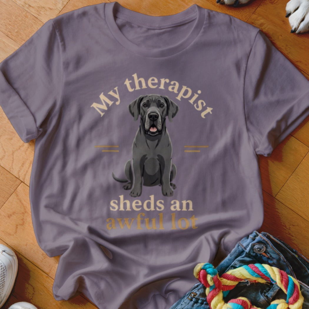 Purple t-shirt with a graphic of a grey Great Dane dog and text "My therapist sheds an awful lot."