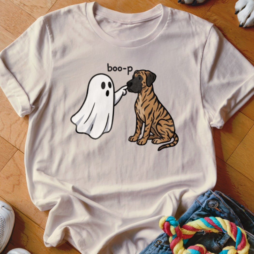 Ghost "boop-p" a tiger-striped dog sitting on a light-colored t-shirt.