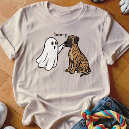 Ghost "boop-p" a tiger-striped dog sitting on a light-colored t-shirt.