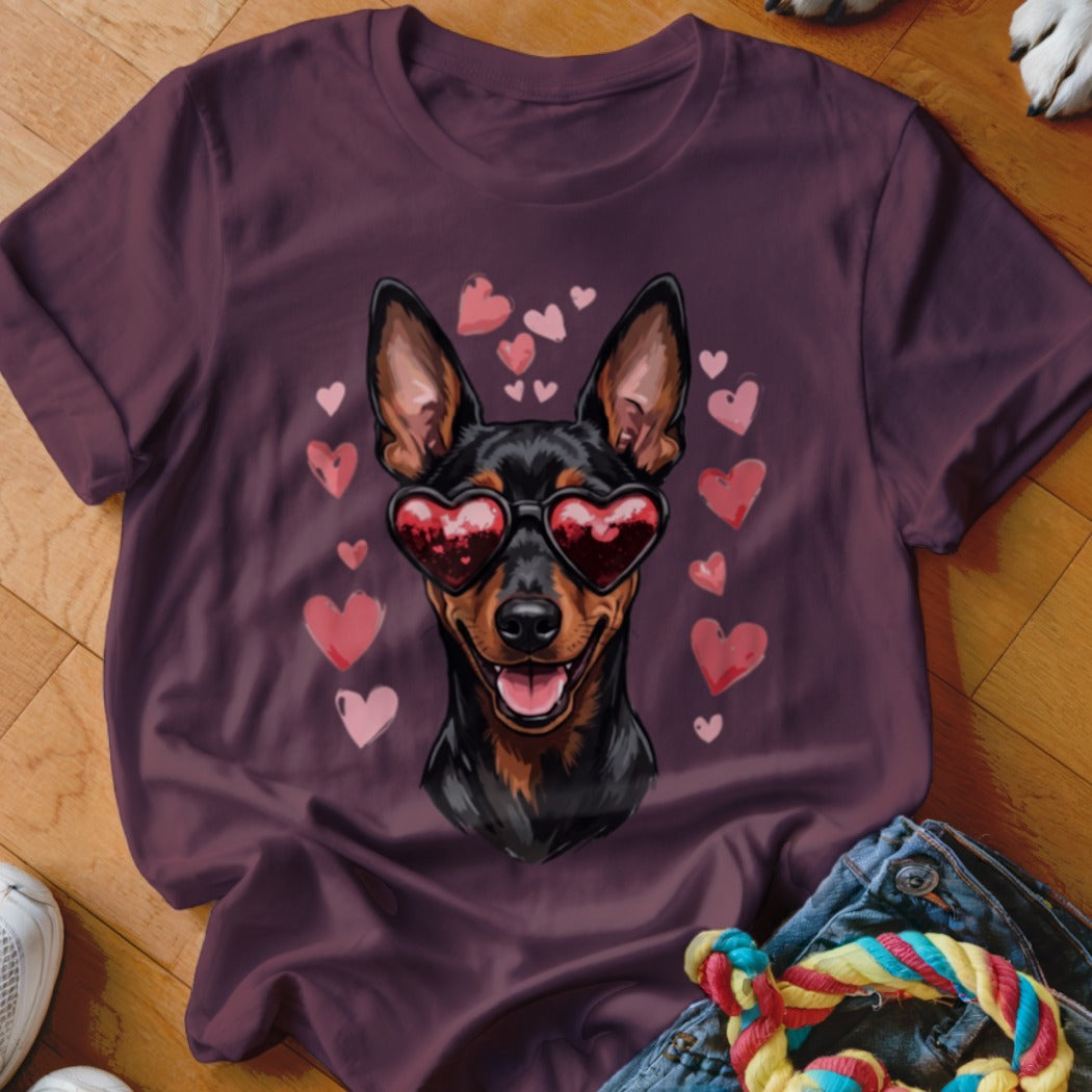 Maroon crewneck t-shirt featuring a graphic of a black and tan dog wearing heart-shaped sunglasses surrounded by pink hearts.
