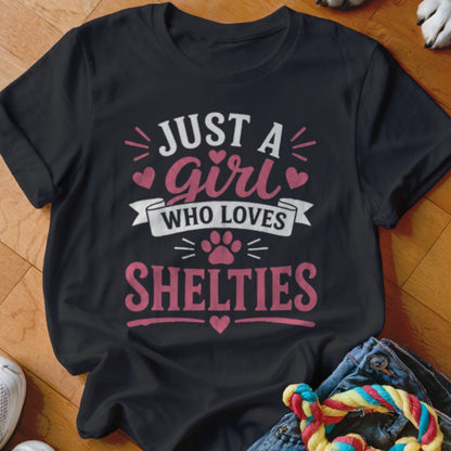Black t-shirt with "Just a girl who loves Shelties" text and paw print graphic.