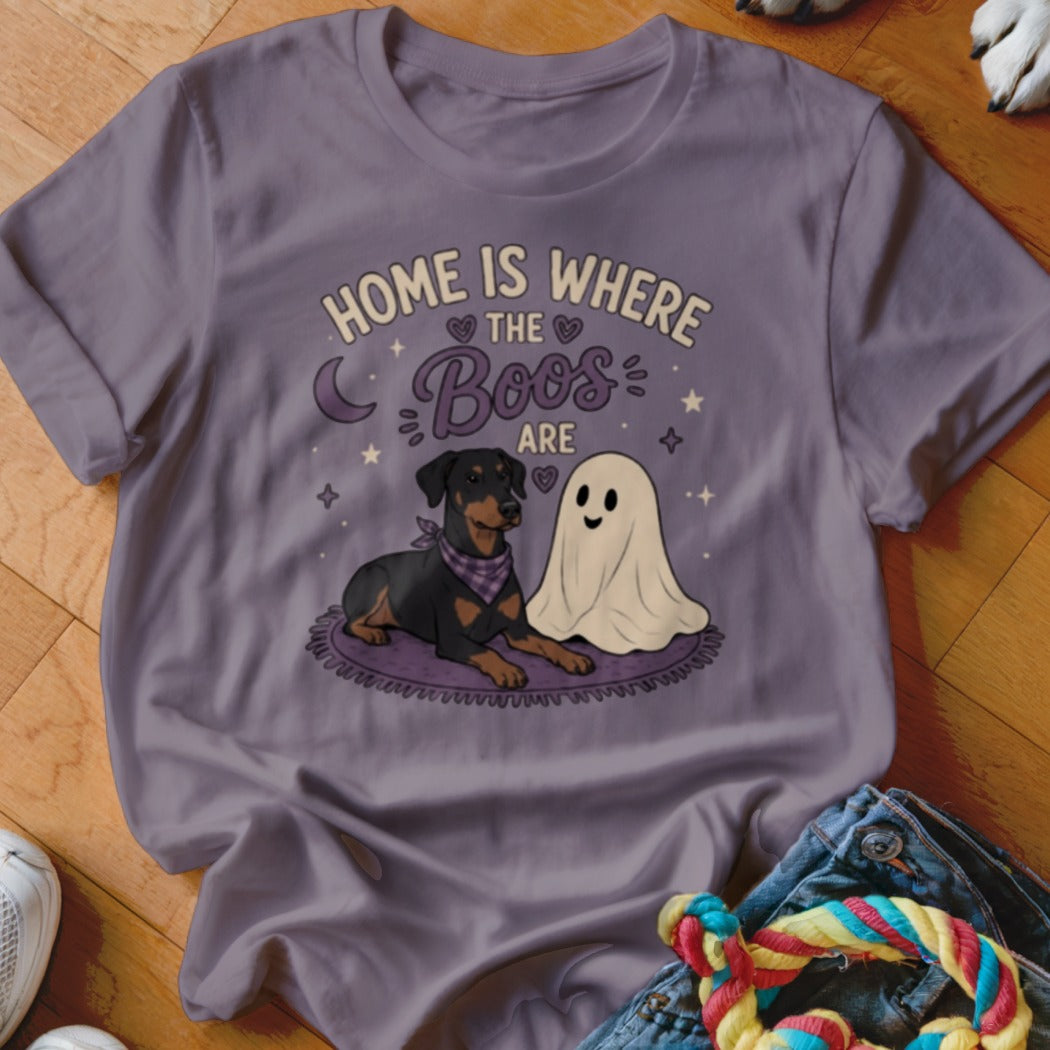 Doberman and ghost sit on rug with text "Home is where the boos are".