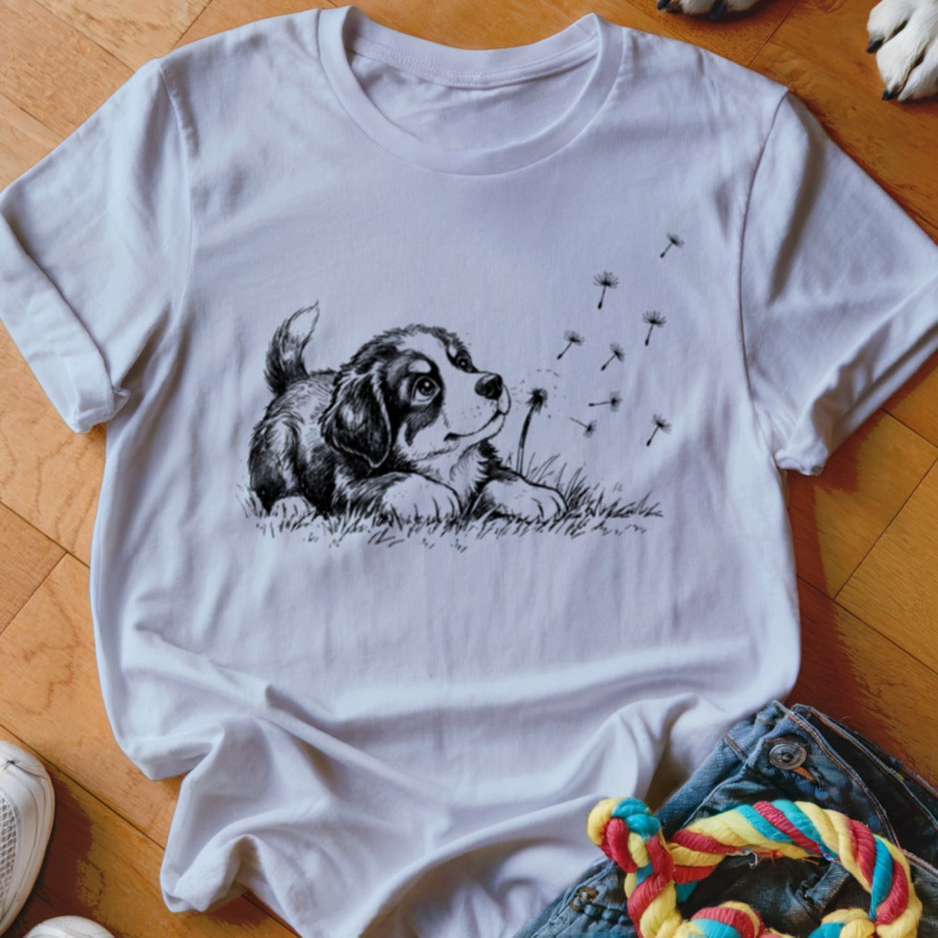 White crewneck t-shirt featuring a black and white sketch of a puppy looking at floating dandelion seeds.