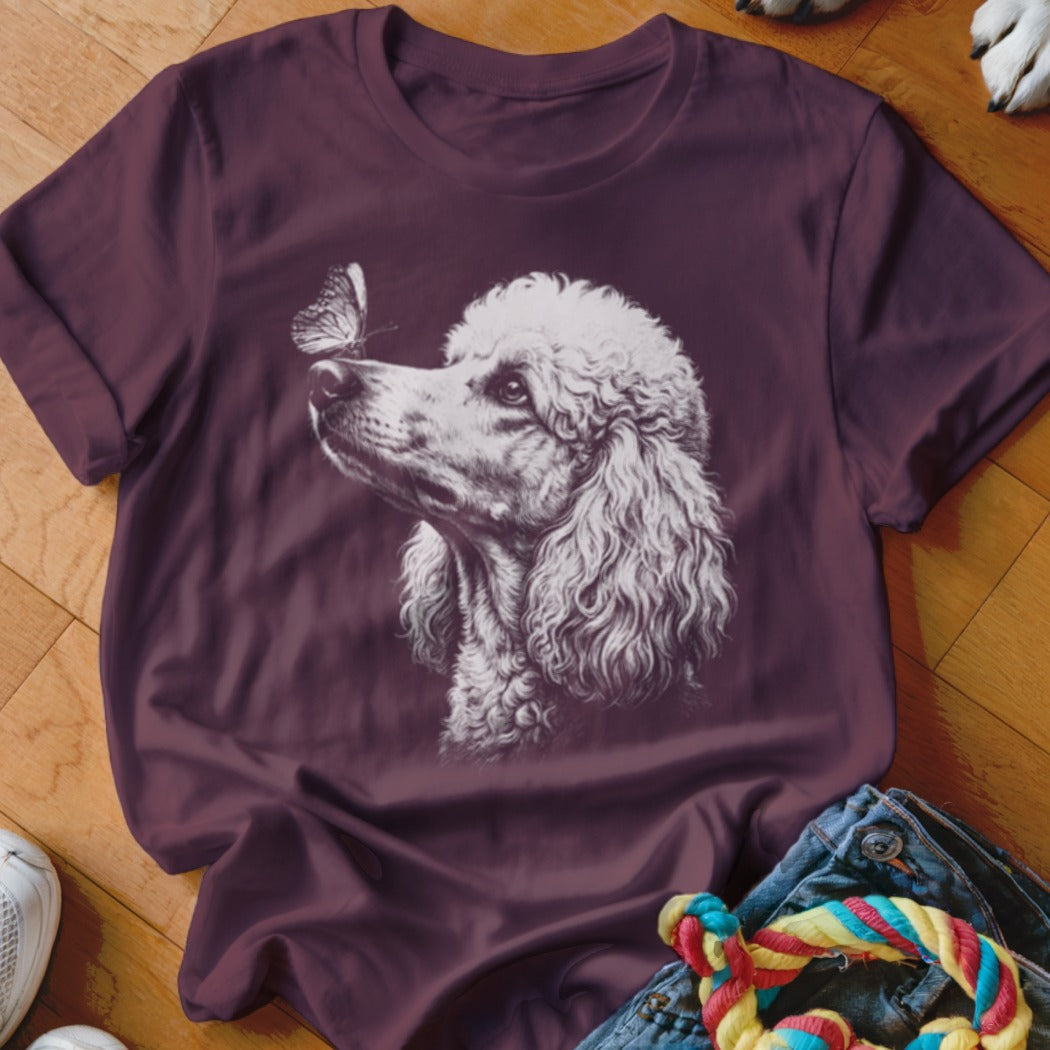 Plum crewneck t-shirt featuring a white line drawing of a poodle with a butterfly on its nose.