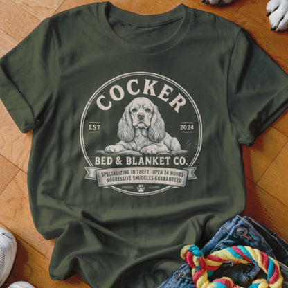 Green t-shirt with Cocker Bed & Blanket Co. logo featuring a dog.