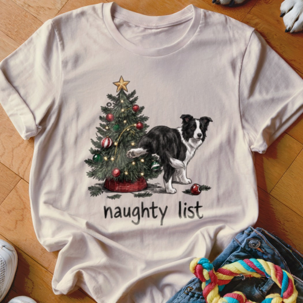 Black and white dog near a Christmas tree with "naughty list" text.