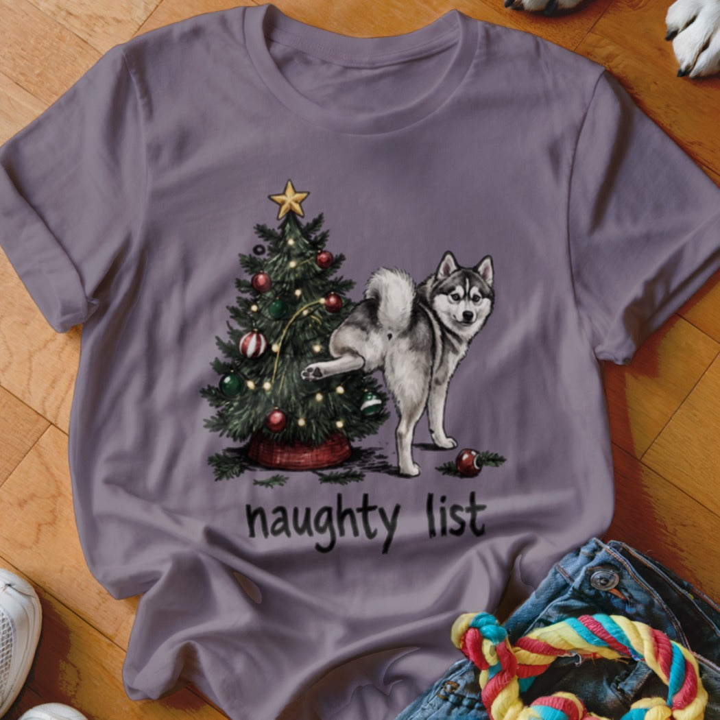 Husky dog peeing on Christmas tree with text "naughty list"