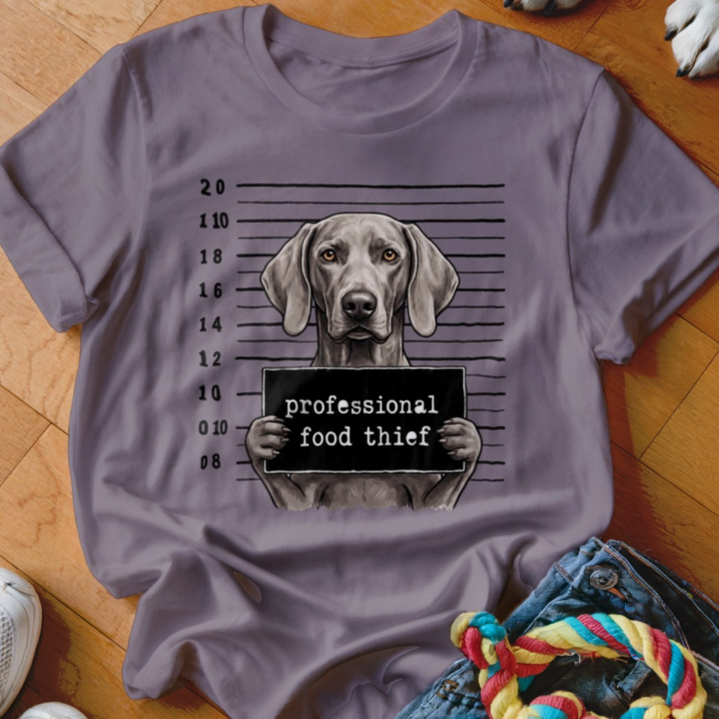 Weimaraner mugshot with sign reading "professional food thief".