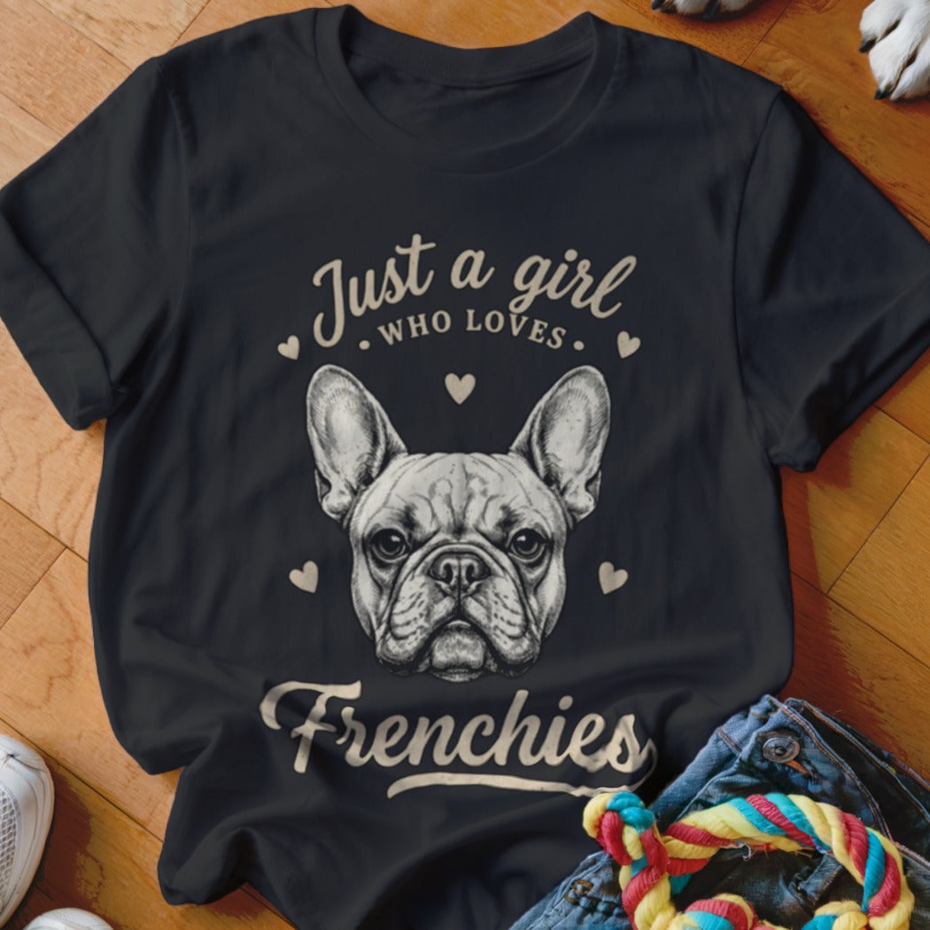A black t-shirt printed with a French bulldog face and the text Just a girl who loves Frenchies.