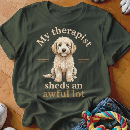 Olive green t-shirt with a dog graphic and "My therapist sheds an awful lot" text.
