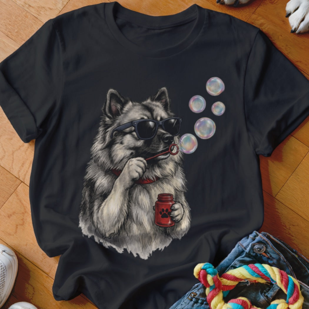 Black t-shirt featuring a graphic of a fluffy dog wearing sunglasses and blowing soap bubbles.