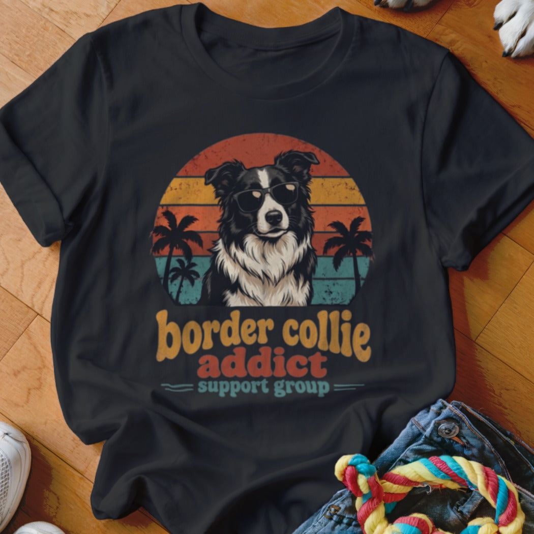 A black t-shirt features a graphic of a Border Collie wearing sunglasses in front of a sunset, with text reading Border Collie Addict Support Group.