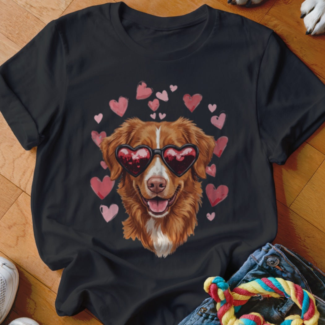 Black t-shirt featuring a graphic of a golden dog wearing heart-shaped sunglasses, surrounded by pink hearts.