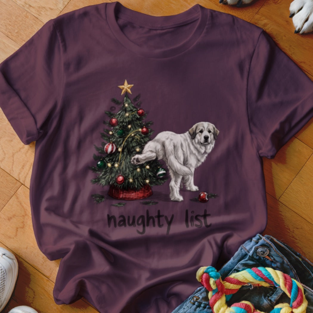 A plum-colored t-shirt with a graphic of a dog peeing on a Christmas tree above the text "naughty list".