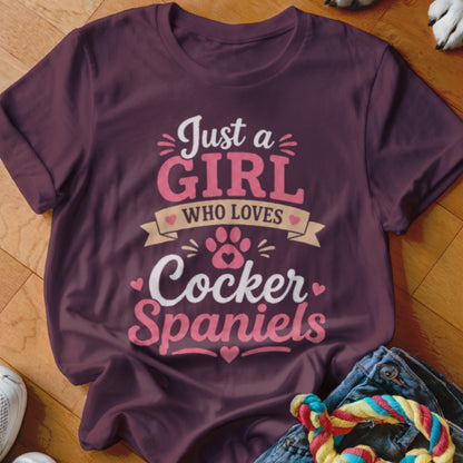 Maroon t-shirt with "Just a Girl Who Loves Cocker Spaniels" text and paw print design.