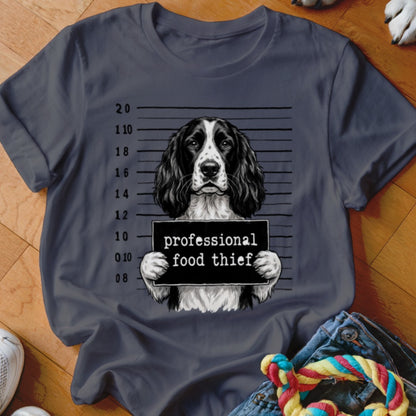 Springer Spaniel mugshot with "professional food thief" text on a dark gray t-shirt.