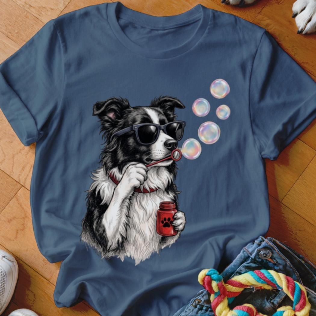 Navy blue t-shirt featuring a graphic of a border collie wearing sunglasses and blowing bubbles.