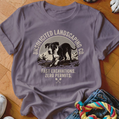 T-shirt with a black and white dog digging, text "Unsolicited Landscaping Co.", and "Fast Excavations. Zero Permits."