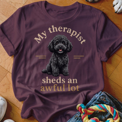 Maroon t-shirt with black poodle illustration and text "My therapist sheds an awful lot".