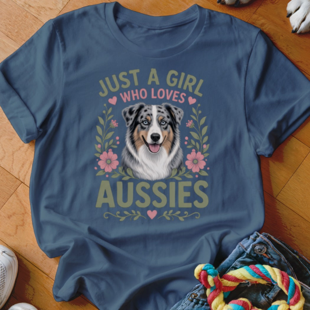 Blue t-shirt with illustration of an Australian Shepherd and text "JUST A GIRL WHO LOVES AUSSIES".