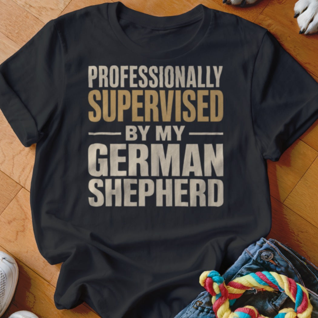 Black t-shirt with text "Professionally supervised by my German Shepherd".