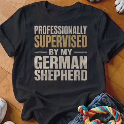 Black t-shirt with text "Professionally supervised by my German Shepherd".
