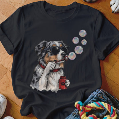 Black t-shirt featuring an illustration of an Australian Shepherd wearing sunglasses and blowing soap bubbles.