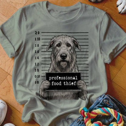 Irish wolfhound mugshot with "professional food thief" sign on a t-shirt.