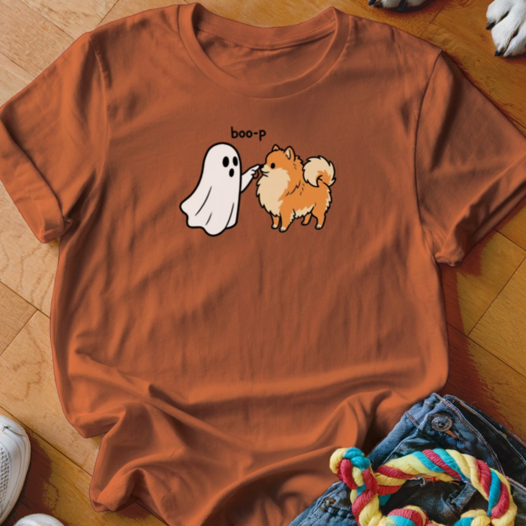 Orange t-shirt with white ghost saying "boo-p" to a fluffy Pomeranian dog.