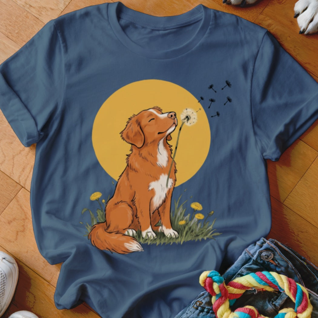 Navy blue t-shirt featuring a cartoon illustration of a brown dog blowing dandelion seeds.