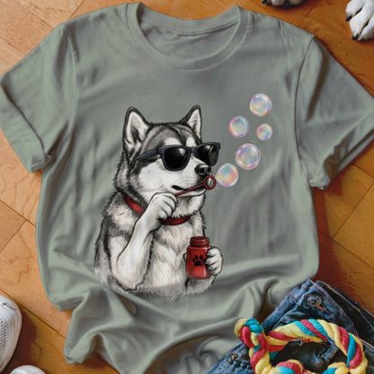 Sage green t-shirt featuring a graphic of a husky wearing sunglasses and blowing soap bubbles.