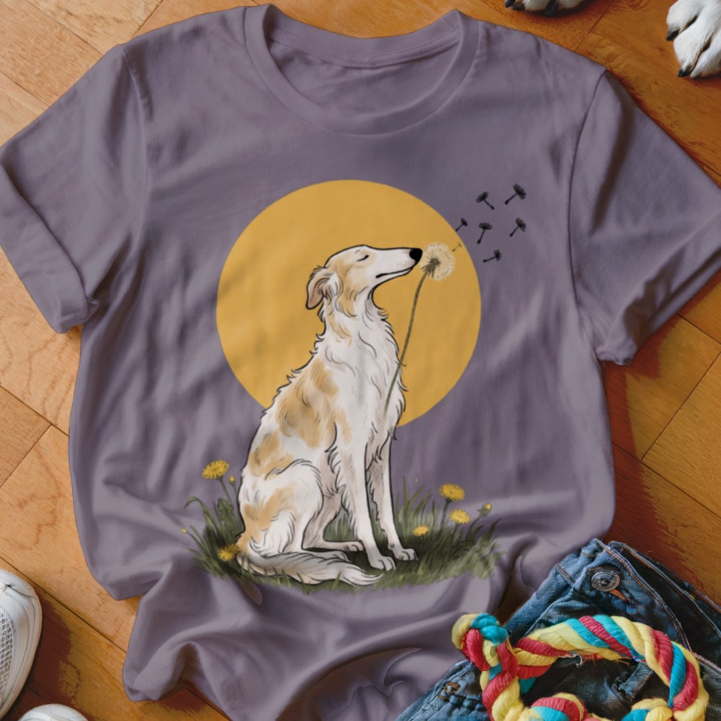 A purple t-shirt featuring an illustration of a dog sitting in grass before a yellow sun.
