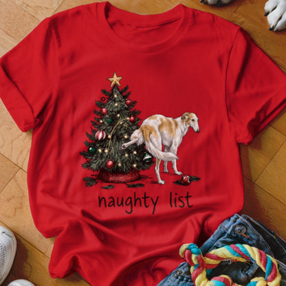 A red t-shirt printed with a Christmas tree and a dog urinating on it above the text naughty list.