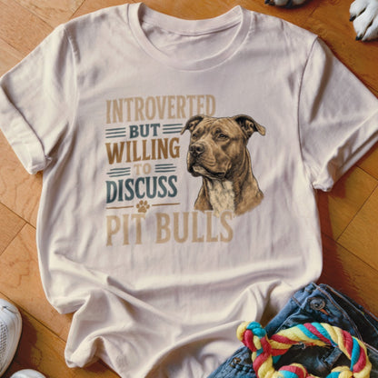 White t-shirt with text "Introverted but willing to discuss pit bulls" and dog illustration.