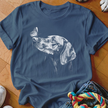 Navy blue short-sleeve t-shirt printed with a white sketch of a dog looking at a butterfly on its nose.