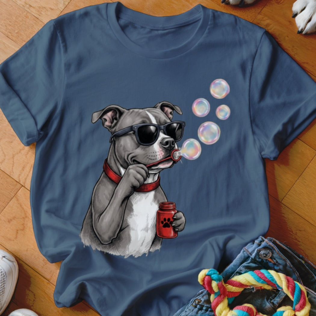 A blue t-shirt printed with a graphic of a pit bull wearing sunglasses and blowing soap bubbles.