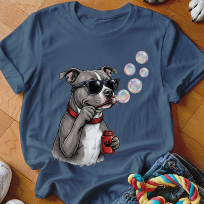 A blue t-shirt printed with a graphic of a pit bull wearing sunglasses and blowing soap bubbles.