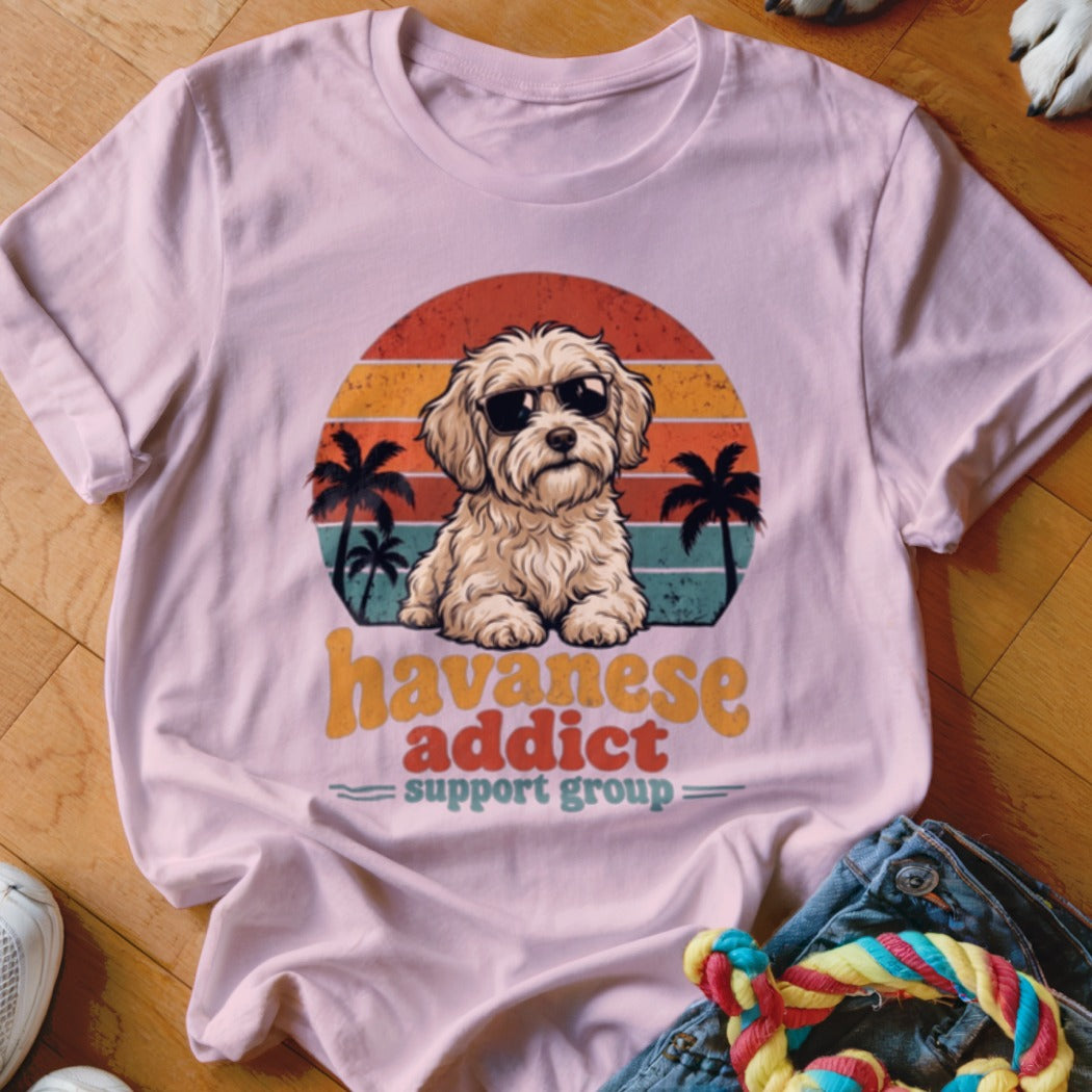 Light pink t-shirt featuring a retro graphic of a Havanese dog wearing sunglasses against a sunset.