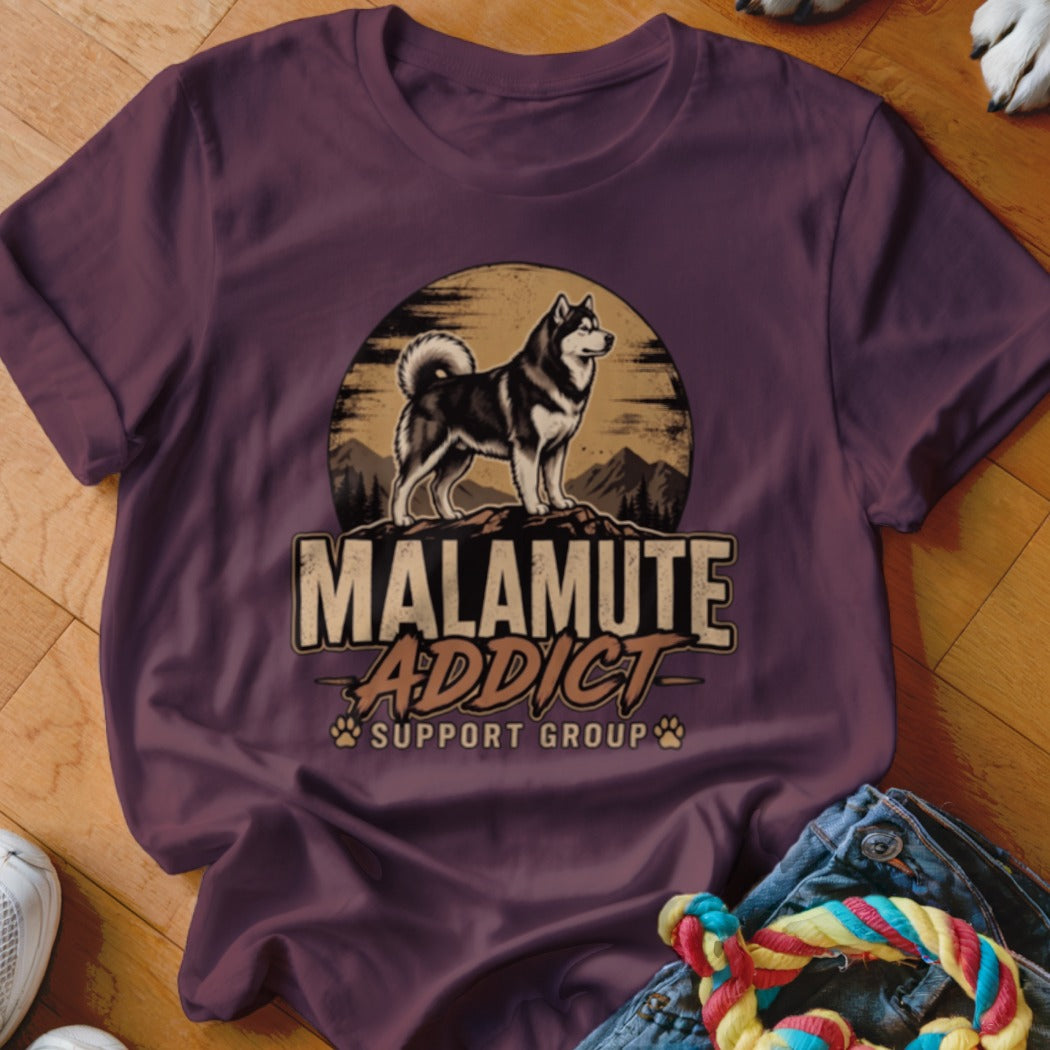 A dark purple crewneck t-shirt featuring a graphic of an Alaskan Malamute and the text Malamute Addict Support Group.