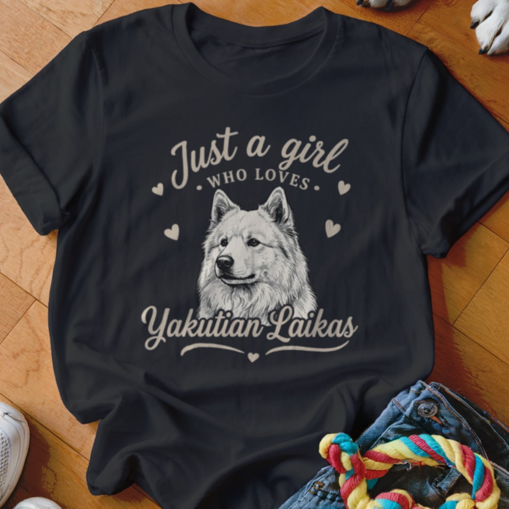 A black t-shirt printed with the text Just a girl who loves Yakutian Laikas and a dog illustration surrounded by hearts.