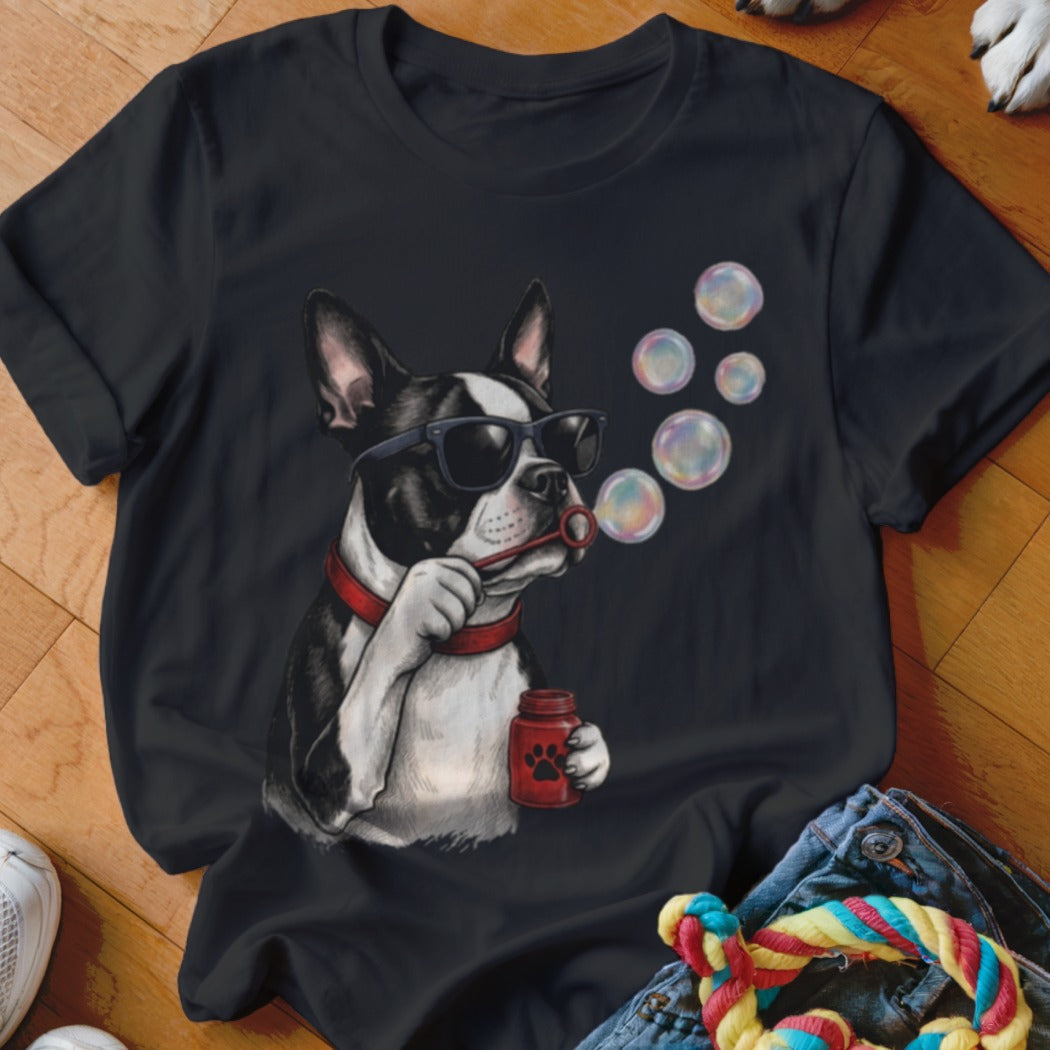 A black t-shirt features a graphic of a Boston terrier wearing sunglasses and blowing soap bubbles.
