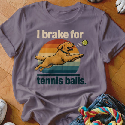 Golden retriever jumps for tennis ball with text "I brake for tennis balls."