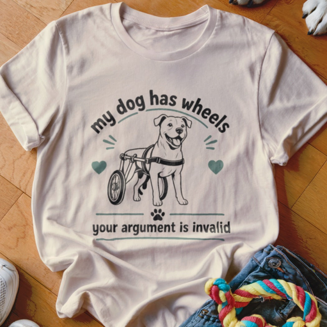T-shirt graphic: dog in wheelchair with text "my dog has wheels your argument is invalid".